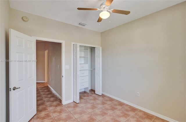 unfurnished bedroom featuring light tile patterned floors, ceiling fan, and a closet