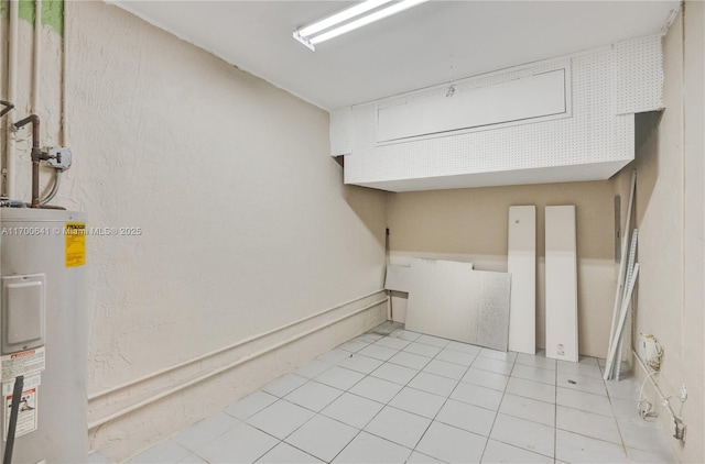 washroom featuring light tile patterned floors and electric water heater