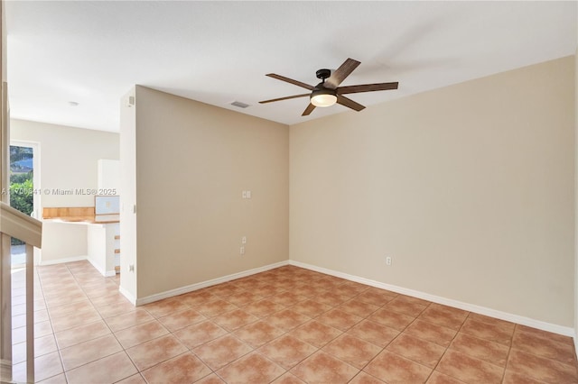 unfurnished room featuring light tile patterned floors and ceiling fan