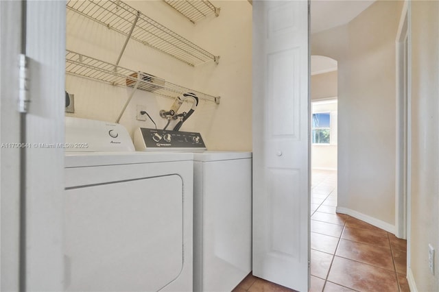 washroom featuring light tile patterned floors and washer and clothes dryer