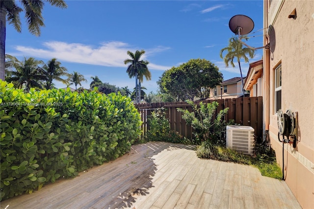 wooden deck featuring central AC unit