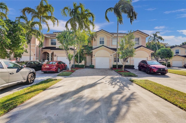 12564 SW 121st Way, Miami, FL 33186 - townhome / multi-family property with an attached garage, driveway, and stucco siding