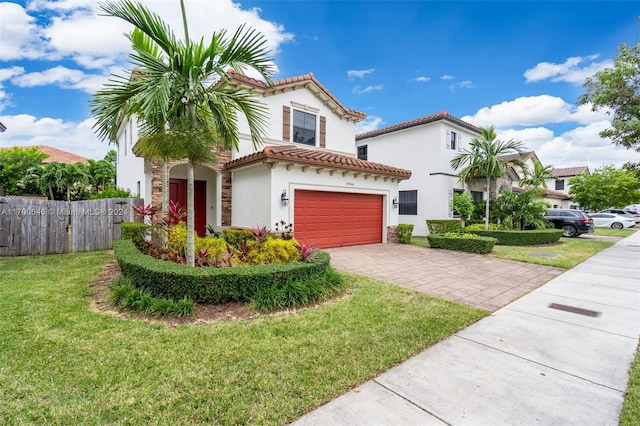 mediterranean / spanish-style house with a front yard and a garage