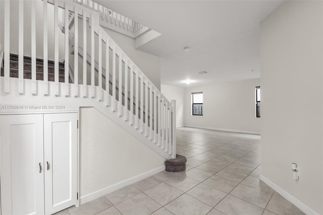 stairs with tile patterned floors