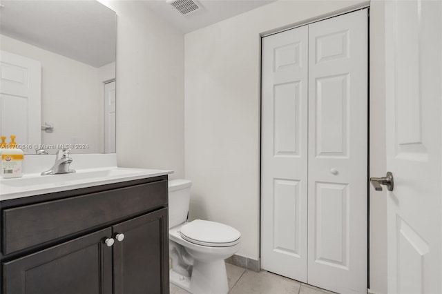 bathroom featuring tile patterned floors, vanity, and toilet