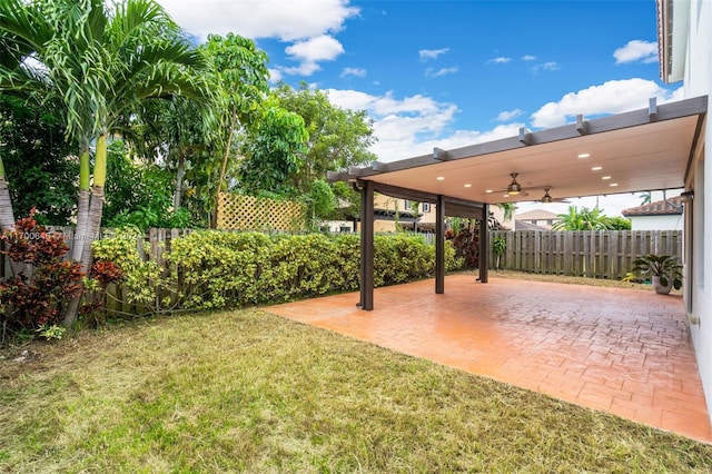 view of yard featuring ceiling fan and a patio area