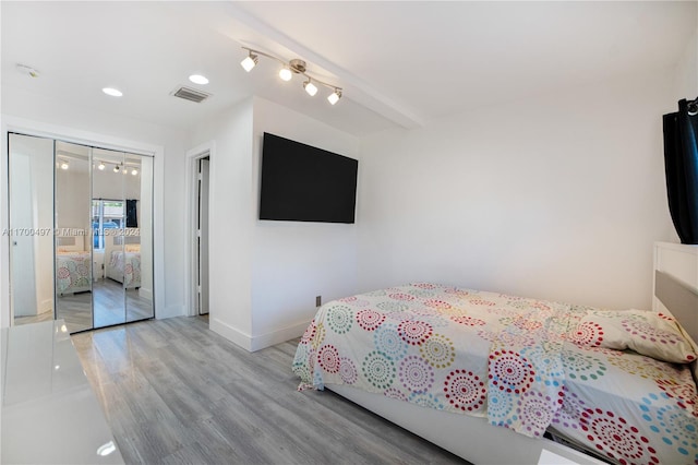 bedroom featuring light hardwood / wood-style floors and a closet