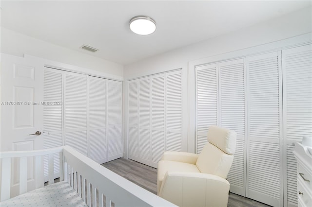 bedroom featuring multiple closets and hardwood / wood-style flooring