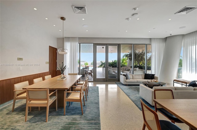 dining room with wood walls