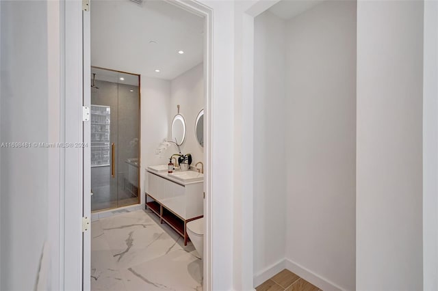 bathroom featuring toilet, vanity, and walk in shower