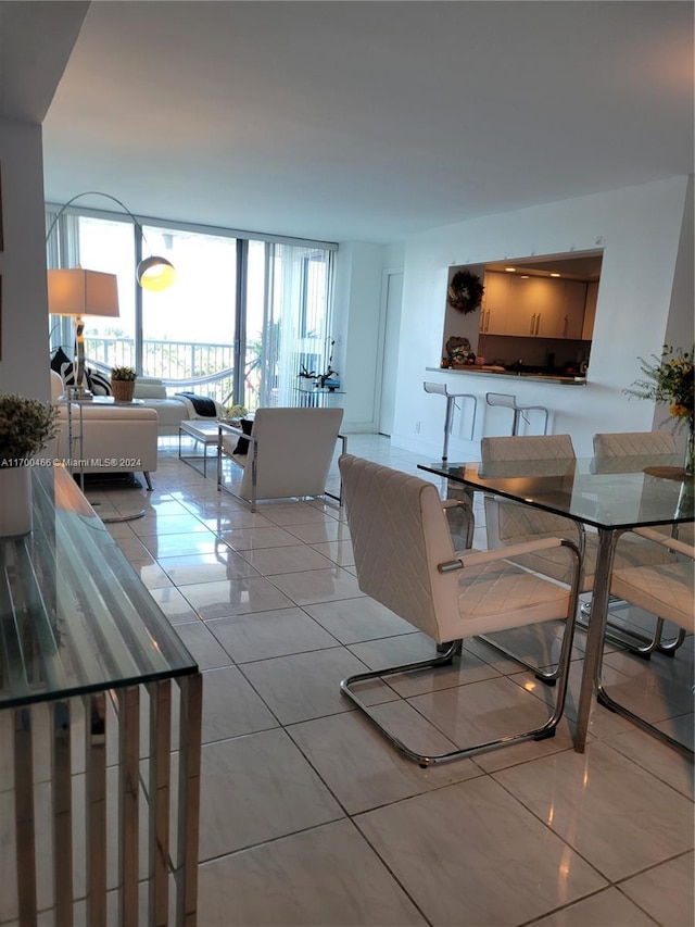 tiled dining room with expansive windows