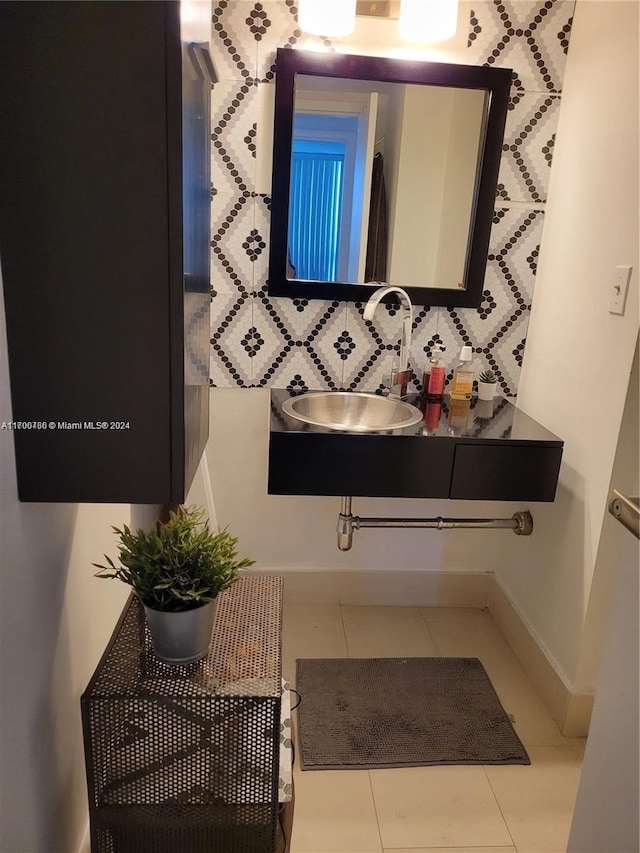 bathroom featuring tile patterned floors, decorative backsplash, and sink