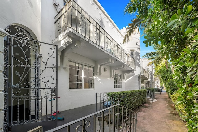 doorway to property featuring stucco siding