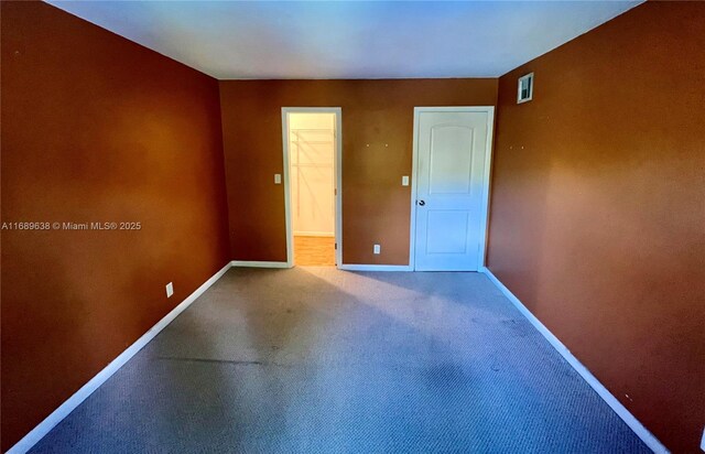 unfurnished room with hardwood / wood-style floors and a textured ceiling