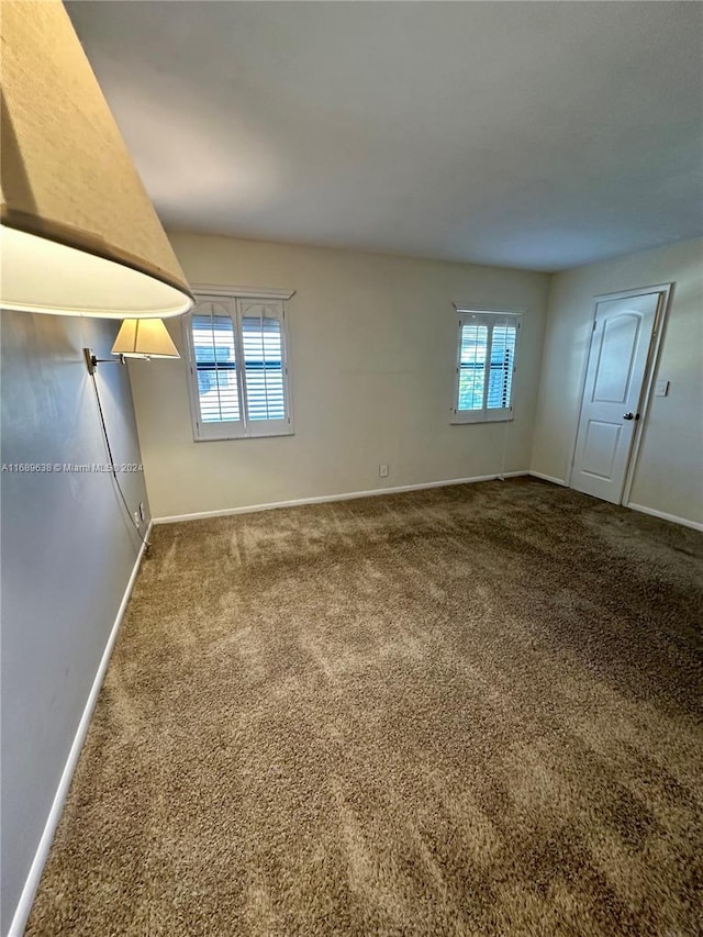 carpeted empty room featuring a wealth of natural light