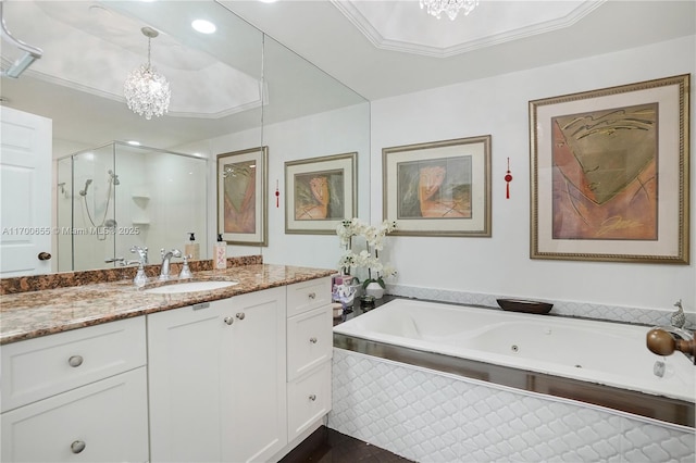 bathroom with vanity, separate shower and tub, ornamental molding, and an inviting chandelier