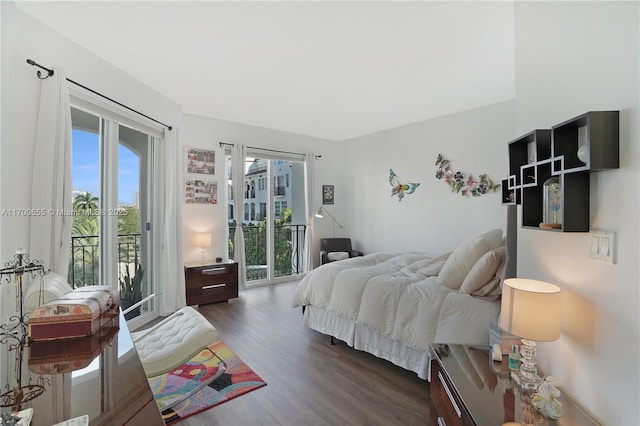 bedroom featuring dark wood-type flooring and access to outside