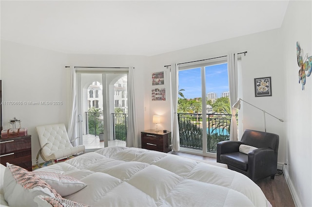 bedroom featuring access to exterior and hardwood / wood-style floors