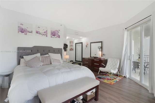 bedroom featuring hardwood / wood-style floors and access to exterior