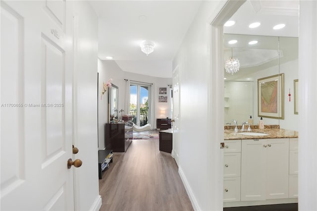 hallway featuring hardwood / wood-style flooring and sink