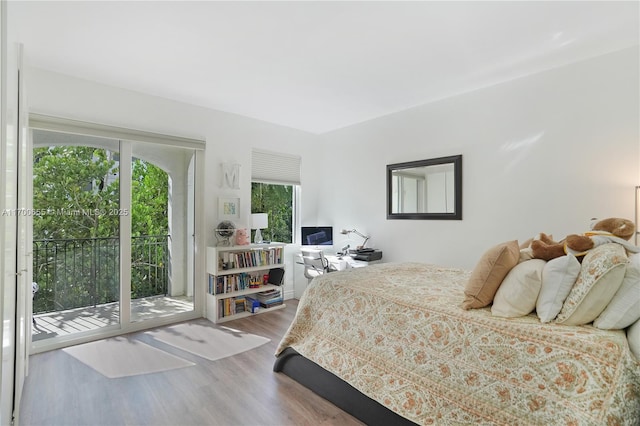 bedroom featuring hardwood / wood-style floors and access to outside