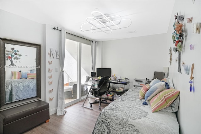 bedroom with wood-type flooring and floor to ceiling windows