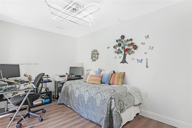 bedroom with wood-type flooring