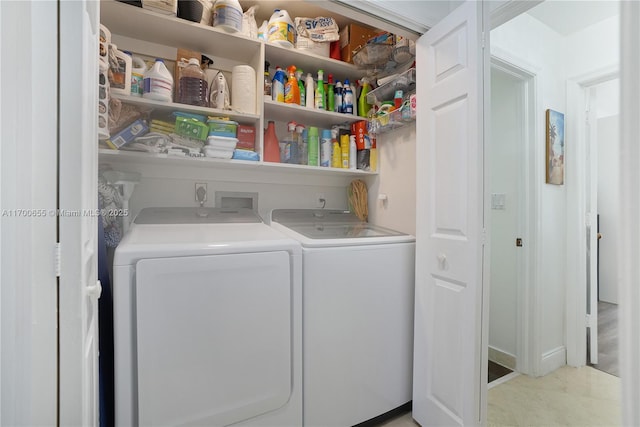 clothes washing area with separate washer and dryer