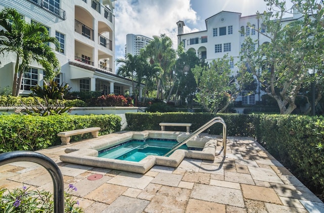 view of pool featuring a patio area and a hot tub