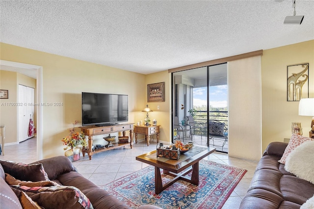 tiled living room featuring a wall of windows and a textured ceiling