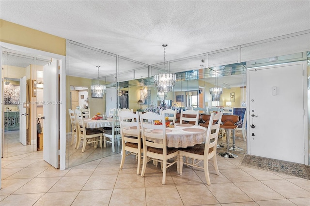 dining room featuring a textured ceiling and light tile patterned flooring