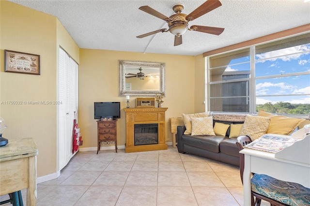 tiled living room featuring ceiling fan and a textured ceiling