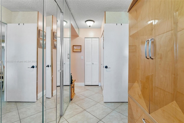 bathroom featuring tile patterned flooring and a textured ceiling