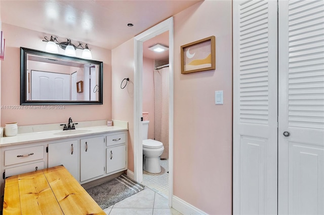 bathroom with tile patterned floors, curtained shower, vanity, and toilet