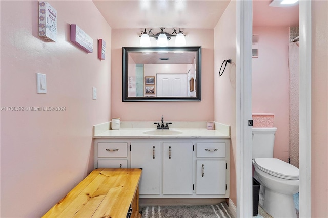 bathroom featuring vanity and toilet