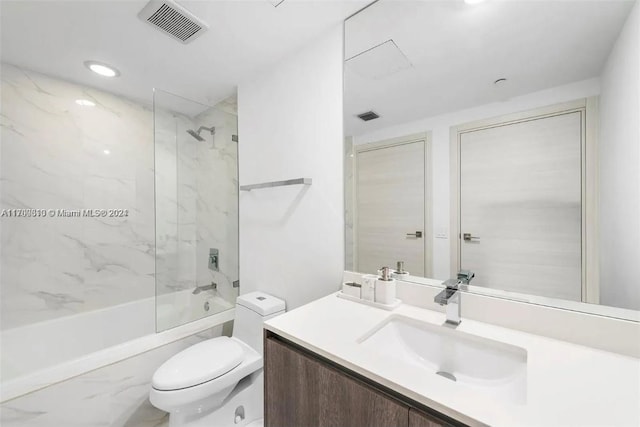 full bathroom featuring vanity, toilet, and tiled shower / bath