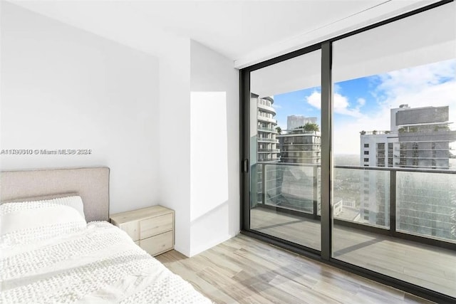 bedroom featuring light hardwood / wood-style floors and floor to ceiling windows