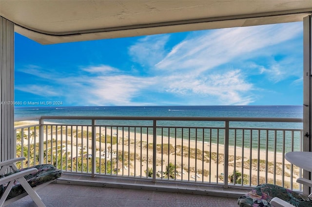 balcony with a water view and a beach view