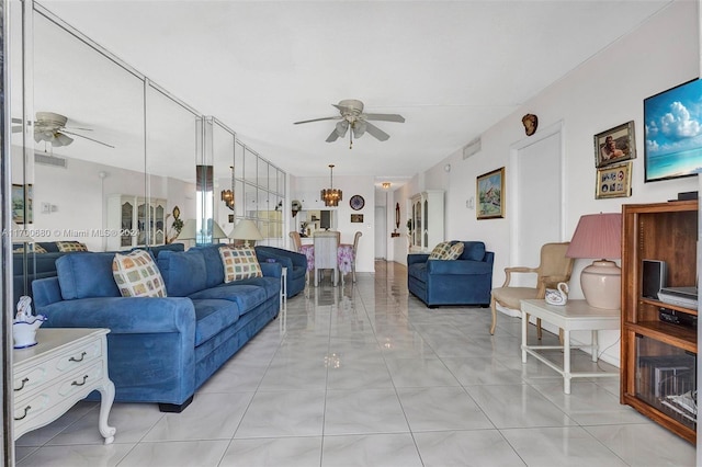 living room with ceiling fan with notable chandelier