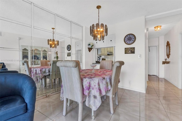 dining room featuring light tile patterned flooring, a textured ceiling, and a chandelier