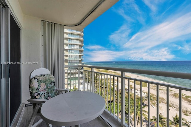 balcony with a water view and a beach view