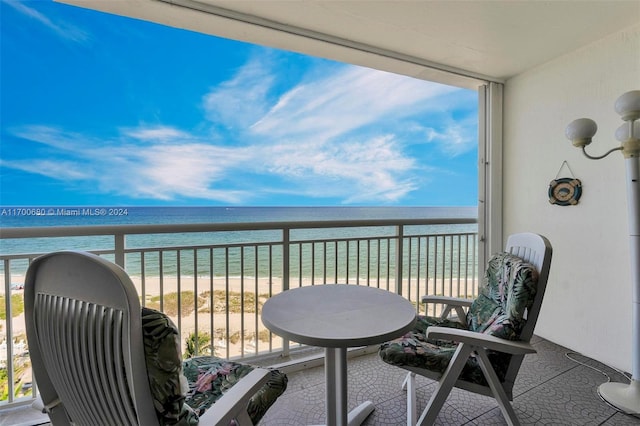 balcony with a view of the beach and a water view