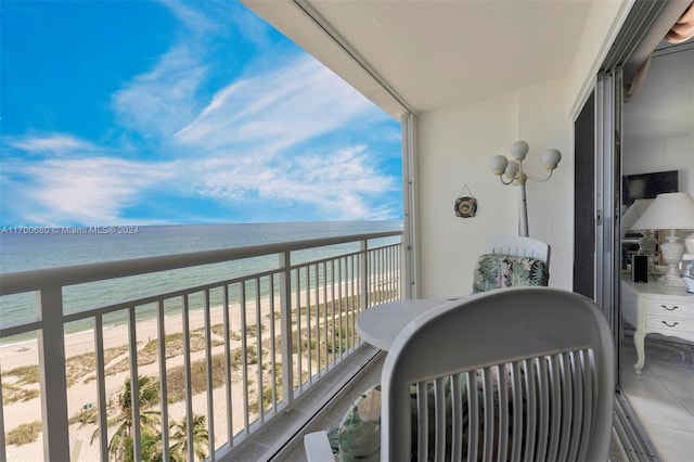 balcony with a water view and a beach view