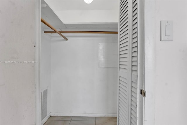 spacious closet with light tile patterned floors