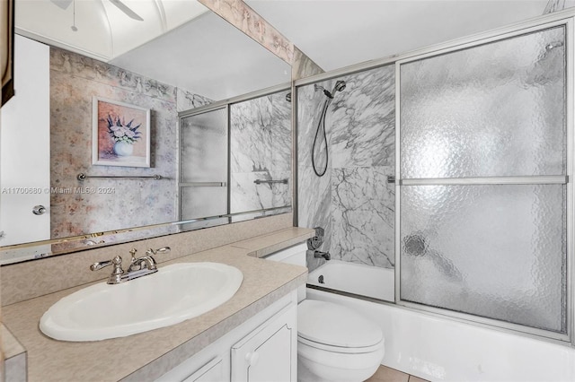 full bathroom with vanity, ceiling fan, toilet, and shower / bath combination with glass door