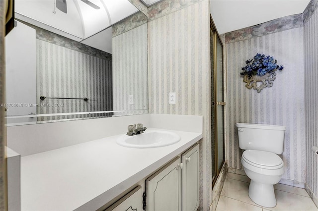 bathroom with tile patterned flooring, vanity, toilet, and ceiling fan