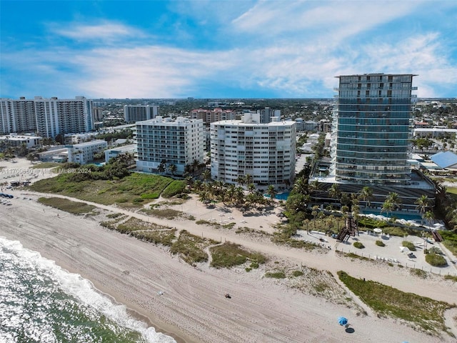 birds eye view of property with a view of the beach and a water view