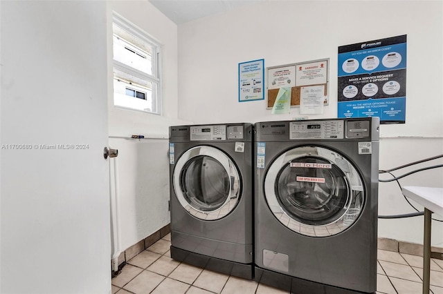 laundry area featuring washer and dryer and light tile patterned floors