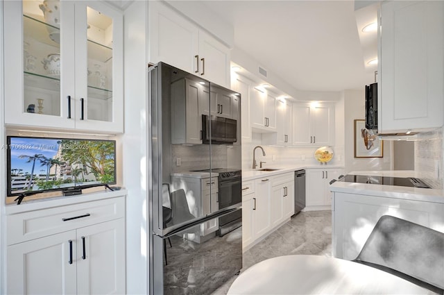 kitchen featuring white cabinetry, sink, and appliances with stainless steel finishes