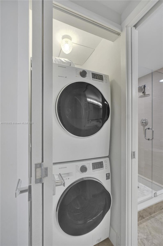 washroom featuring stacked washer and dryer